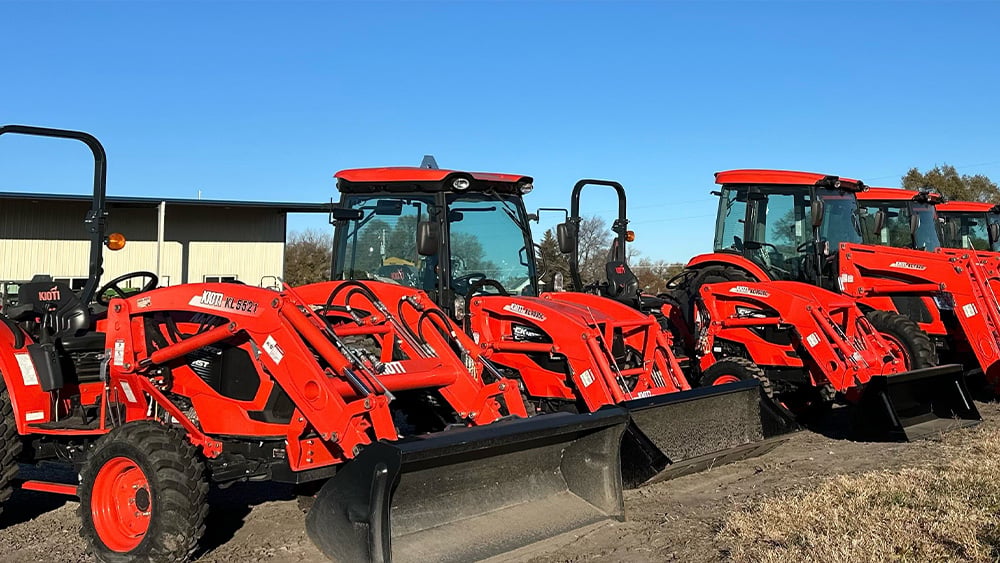 Kubota compact tractors and regular tractors lined up