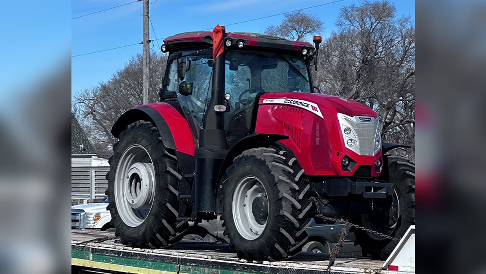 Kubota tractor being moved on a trailer