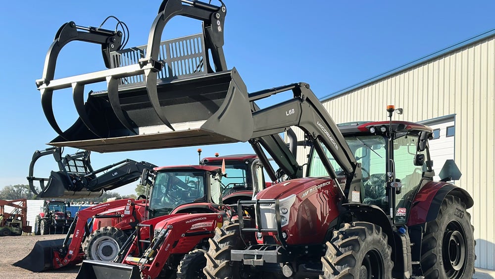 Another angle of a Kubota tractor with its hay bale attachment up