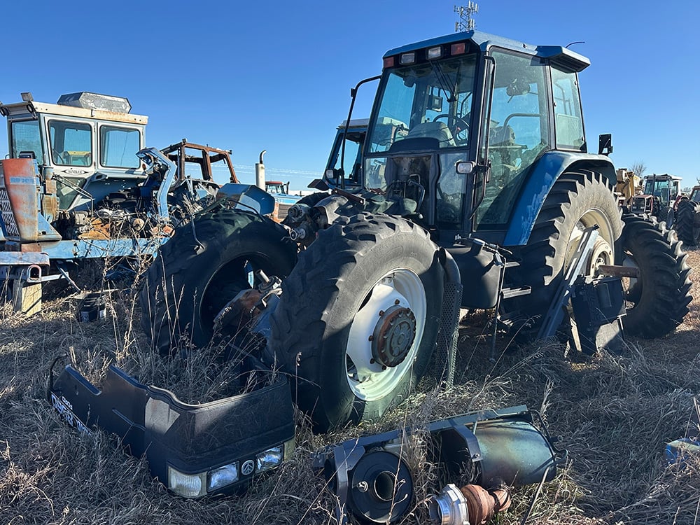 Blue salvaged tractor missin entire front engine