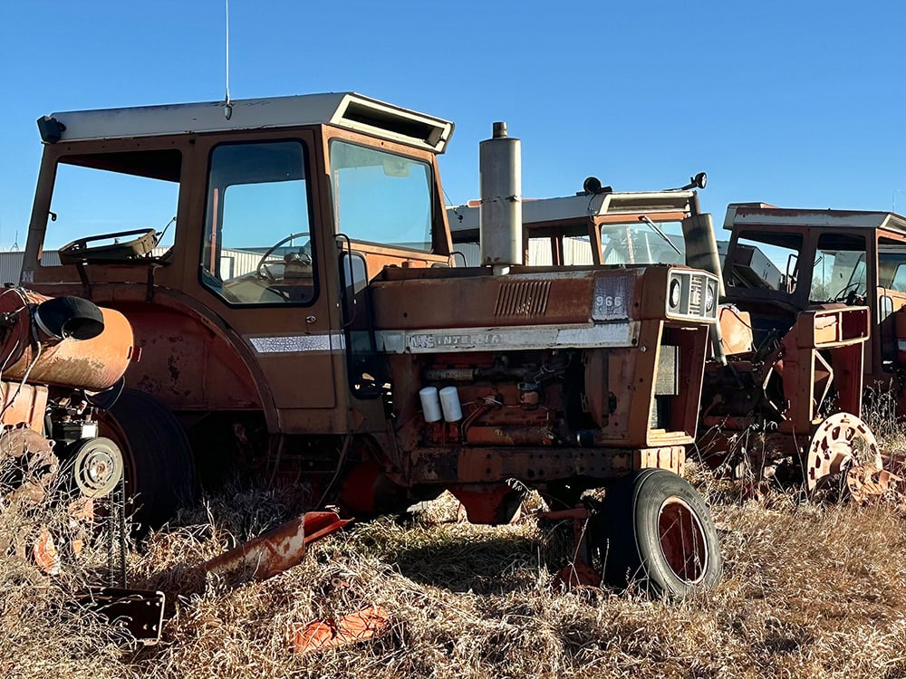 Large international tractors in a row on display, most are missing front wheels