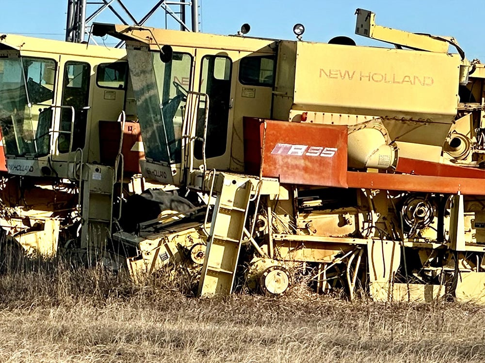 New Holland salvaged harvestor TR96 in a row