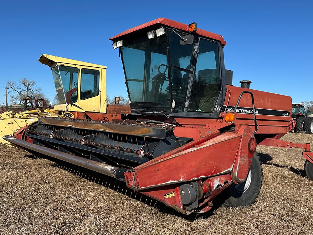 Red and yellow salvaged harvestors being displayed