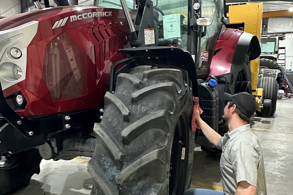 Employee working on a Mccormick Tractor